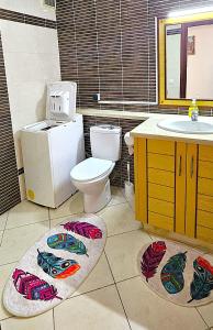 a bathroom with a toilet and a sink at Plein centre, plage & souks à deux pas ! in Agadir +11 photos