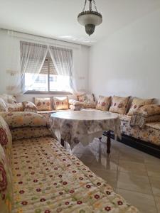 a living room with a couch and a table at apartment in centre ville in Rabat