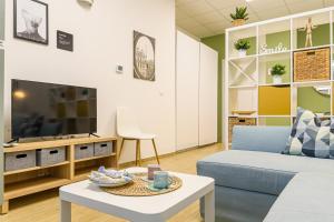 a living room with a couch and a tv at Open Space Romagna 14 in San Benedetto del Tronto