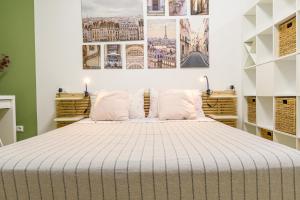a bedroom with a large bed with white sheets at Open Space Romagna 14 in San Benedetto del Tronto