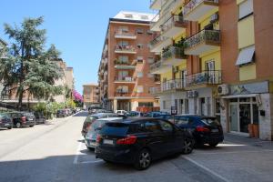 a row of cars parked next to a building at Open Space Romagna 14 in San Benedetto del Tronto