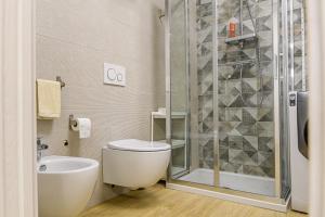 a bathroom with a shower and a toilet and a sink at Open Space Romagna 14 in San Benedetto del Tronto +15 photos