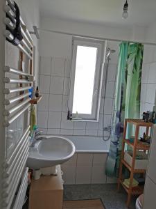 a bathroom with a sink and a window at Nettes Schlafzimmer mit Gemeinschaftsbad in zentraler Lage in Bremen +6 photos