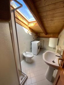 a bathroom with a toilet and a sink and a window at Residence Alberghiero Splendor in Folgarida +57 photos