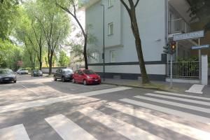 a street with cars parked on the side of a building at Hotel Pone in Sesto San Giovanni