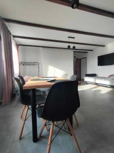 a table and chairs in a room with a bedroom at Apartamenty u Anety in Wilkasy