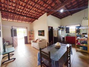 a living room with a table and a couch at Paraíso Particular- Casa na Praia De Camurupim- Pedra Oca in Nísia Floresta