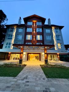 a large building with a pathway leading to it at Sensacional Flat Serra Class - vista do Pôr do Sol in Canela