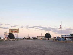 a parking lot with a sign and a sign for a motel at Prairie Falcon 4 in Valle +3 photos
