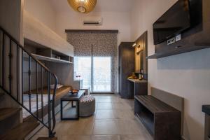 a small room with a staircase and a living room at Chasapis Luxury Apartments&Studios in Vourvourou