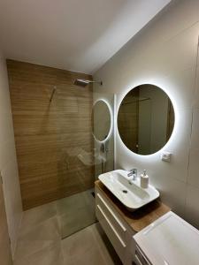 a bathroom with a sink and a mirror at Apartment Ivan in Mostar +9 photos
