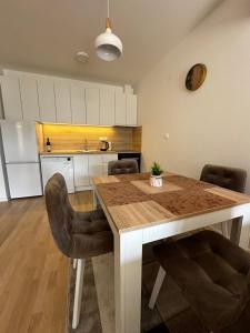 a kitchen with a dining room table and chairs at Apartment Ivan in Mostar
