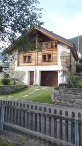a house with a fence in front of it at Chalet Charm in Molare