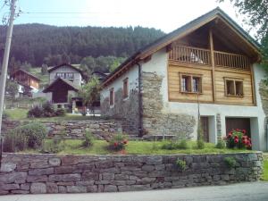 a stone building with a balcony on top of it at Chalet Charm in Molare