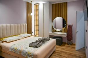 a bedroom with a bed with towels on it at Hata Luxury Apartments in Shkodër