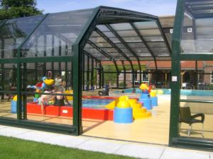 a playground with a pool with people playing in it at Stekkie 49 in Schagen