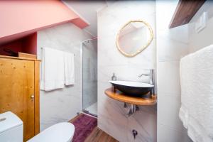 a bathroom with a sink and a mirror at Montanhas do Xisto - Solar do Xisto Nascente in Candal +23 photos