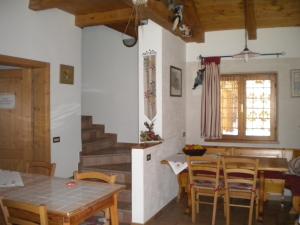 eine Küche und ein Esszimmer mit einem Tisch und Stühlen in der Unterkunft Bed and Breakfast Cappeler in Tione di Trento