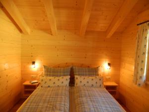 a bedroom with a bed in a wooden room at Haus Schwaiger in Bad Hofgastein