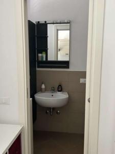 a bathroom with a sink and a mirror at DolceVita Airport in Ponte Galeria