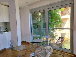 a dining room with a glass table and chairs at Nature Escape Amazing Sea View in Budva