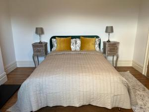 a bedroom with a large bed with two night stands at The Old School House in Bristol