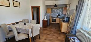 a kitchen and dining room with a table and chairs at Podere Miray in Torre di Palme