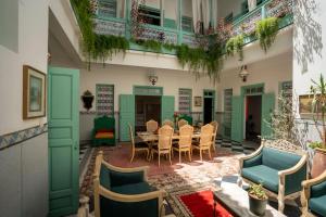 a patio with a table and chairs in a building at Charming Medina Riad 8 rooms with pool - Riad INN Medina in Marrakech