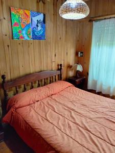 a bedroom with a bed and a chandelier at Casa de Playa in Santa Clara del Mar