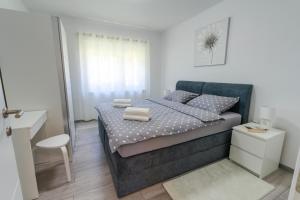 a bedroom with a bed with towels on it at Lusi in Otočac