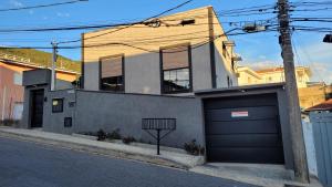 a house with two garage doors on a street at Perfeito Studio 21 in Poços de Caldas
