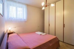 Postel nebo postele na pokoji v ubytování Casa Vacanze Dalisa Ulivo B con Parcheggio