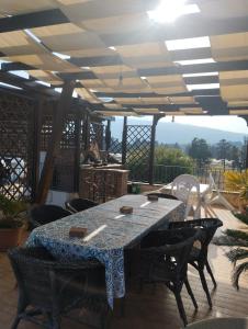 a patio with a table and chairs on a deck at Casa al mare Sicilia in Fondachello +7 photos