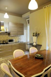 eine Küche mit einem Holztisch und Stühlen in der Unterkunft Alexia Home in Rom