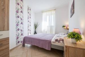 a bedroom with a bed with a purple blanket at Villa Nada with 6 bedrooms in Vodnjan +55 photos