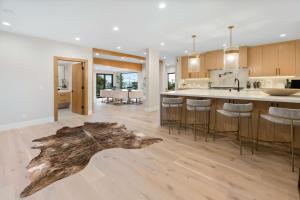 a kitchen and living room with a log on the floor at Sea Vista in Malibu