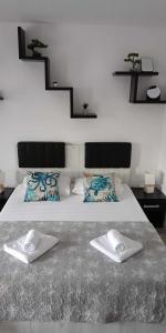 a bedroom with a bed with two towels on it at Garsoniera Saturn in Saturn