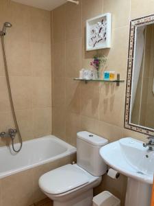 a bathroom with a toilet and a tub and a sink at Santuario San José in San José +37 photos