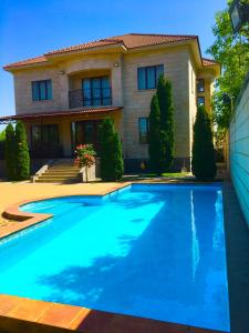 a house with a swimming pool in front of a house at Luxury villa in Yerevan
