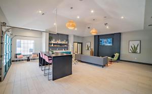 a lobby with a bar and a living room at Spacious 2BR King Suites w Pool, Gym, Laundry - Close to Downtown in Austin