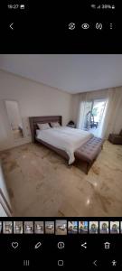 een foto van een slaapkamer met een bed en een raam bij Front Beach - Bahia Golf Beach in Bouznika