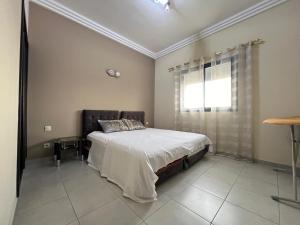 a bedroom with a large bed and a window at Sweet Jacob's City Center in Agadir