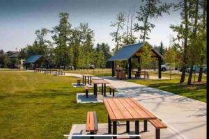 a group of picnic tables in a park at Cozy Lodge Suite in Sylvan Lake