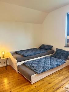 Postel nebo postele na pokoji v ubytování Ferienwohnung Am Langenberg