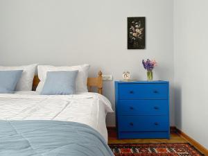 a bedroom with a blue dresser next to a bed at Your Cascade Home: In Yerevan Heart in Yerevan
