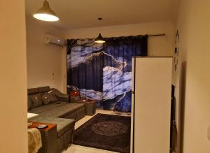 a living room with a couch and a refrigerator at السخنة هيلز مدينة الجلالة Sokhna Hills Al Galala City Family only in Ain Sokhna