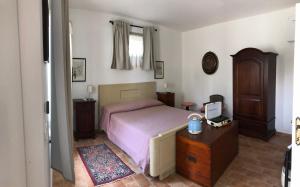 a bedroom with a bed and a wooden dresser at Villa Francesca Luxury - Adriatic Nature & Heritage House in Grottammare
