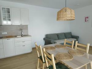 a kitchen and dining room with a table and chairs at Apartma Edra - Žusterna in Koper