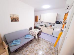 a kitchen with a couch and a table in a room at Casa dei Trabocchi 2-3 in San Vito Chietino +6 photos