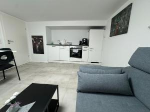 a living room with a couch and a table at Rhein Appartements in Rheinhausen